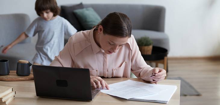 Mother working at home while on family leave