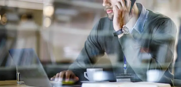 Company whistleblower talking on the phone while at work